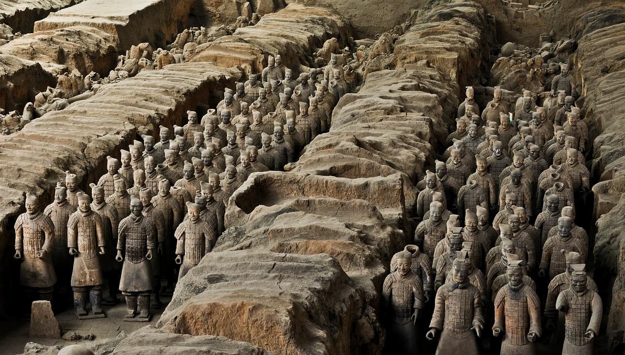 Children observing terracotta warriors at excavation site