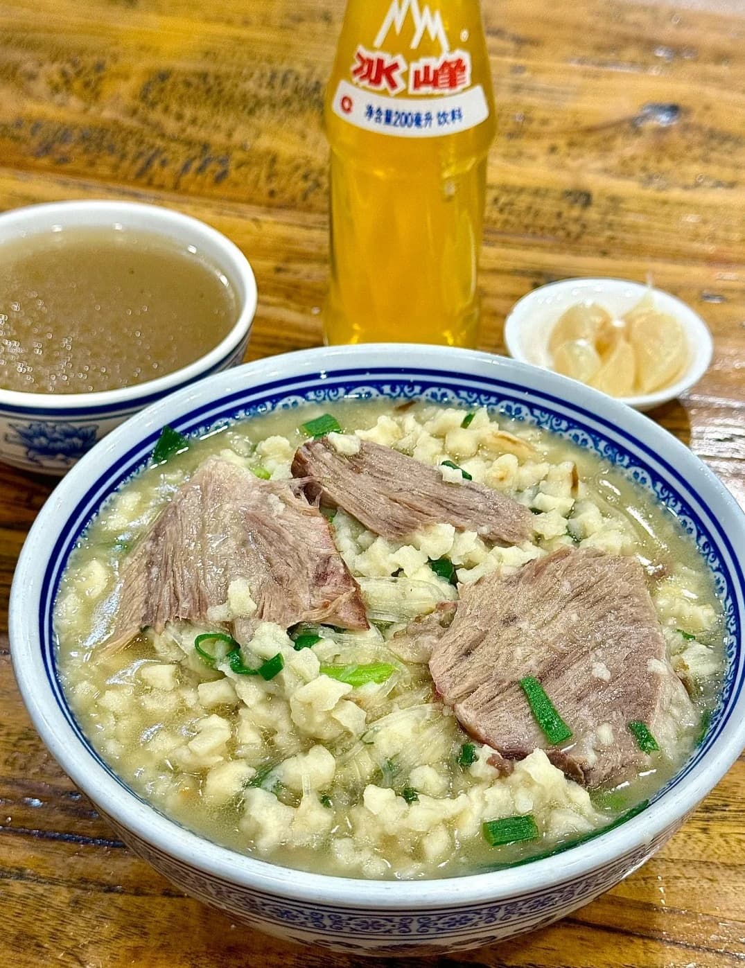 Traditional lamb soup with broken flatbread in clay pot